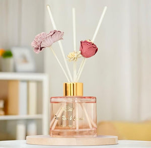 Diffuser with floral reeds on a light background
