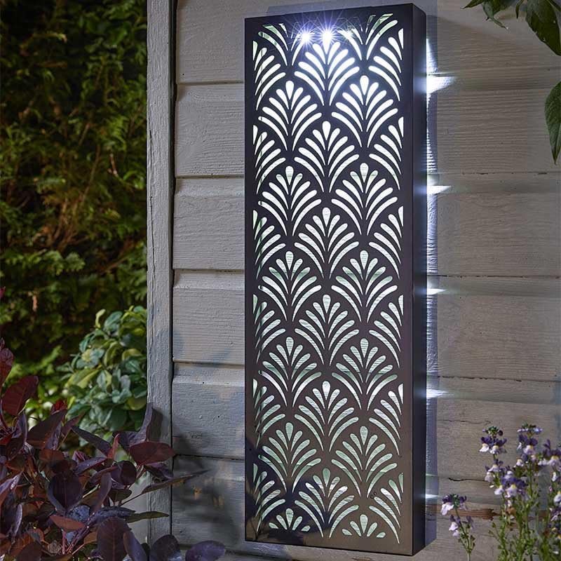 Decorative outdoor light fixture with geometric pattern on a wall.