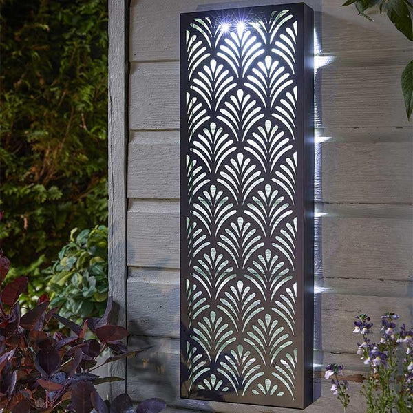 Decorative outdoor light fixture with geometric pattern on a wall.