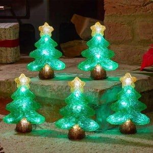 Set of LED Christmas tree lights on a stone surface with a rustic background.