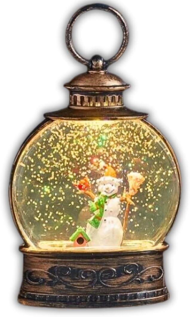 A Christmas lantern tree ornament featuring a snowman inside a snow globe, with warm white LEDs illuminating the scene, placed on a table.
