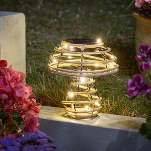 Solar-powered outdoor light with flowers in the background