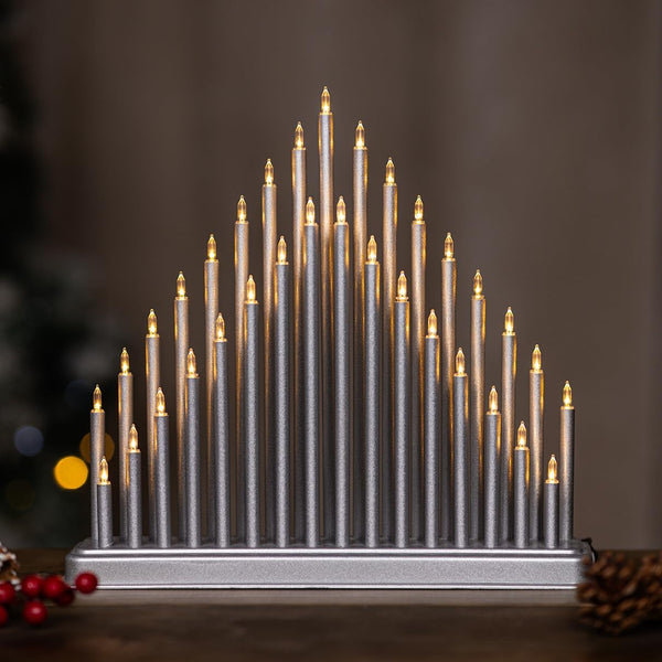 Decorative candle-like structure with lights on a blurred background