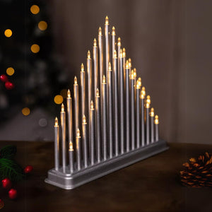 Decorative candle display with lit candles on a dark background