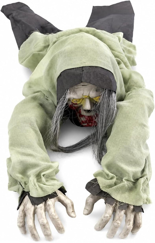 A creepy Halloween prop of a zombie or ghoul crawling forward on a white background. The figure has a tattered light green hooded robe, long gray hair, a decayed pale face with yellow eyes and a bloody mouth, and skeletal hands.