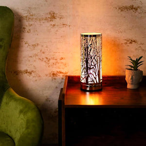 Decorative lamp on a wooden surface with a textured wall background