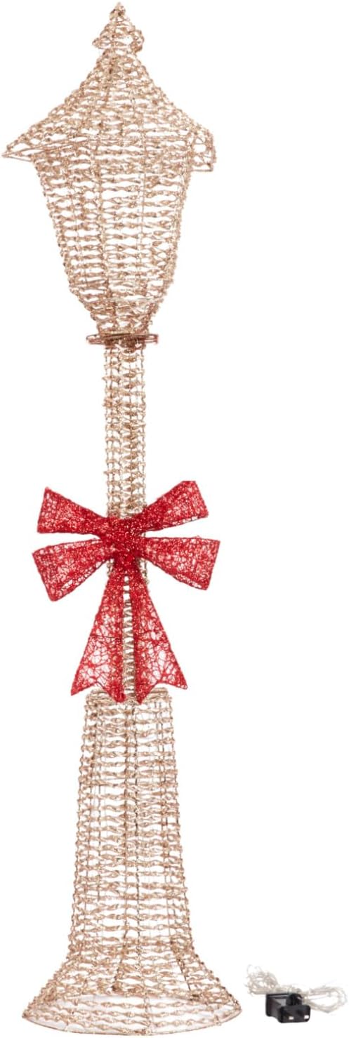Decorative lamp post with a red bow on a white background