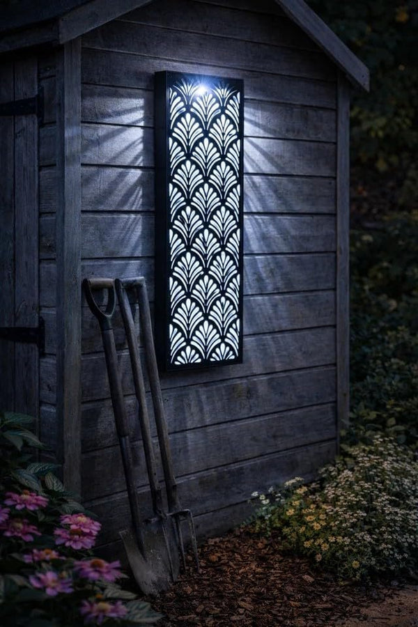 Decorative wall light on a wooden shed exterior with garden tools and flowers.