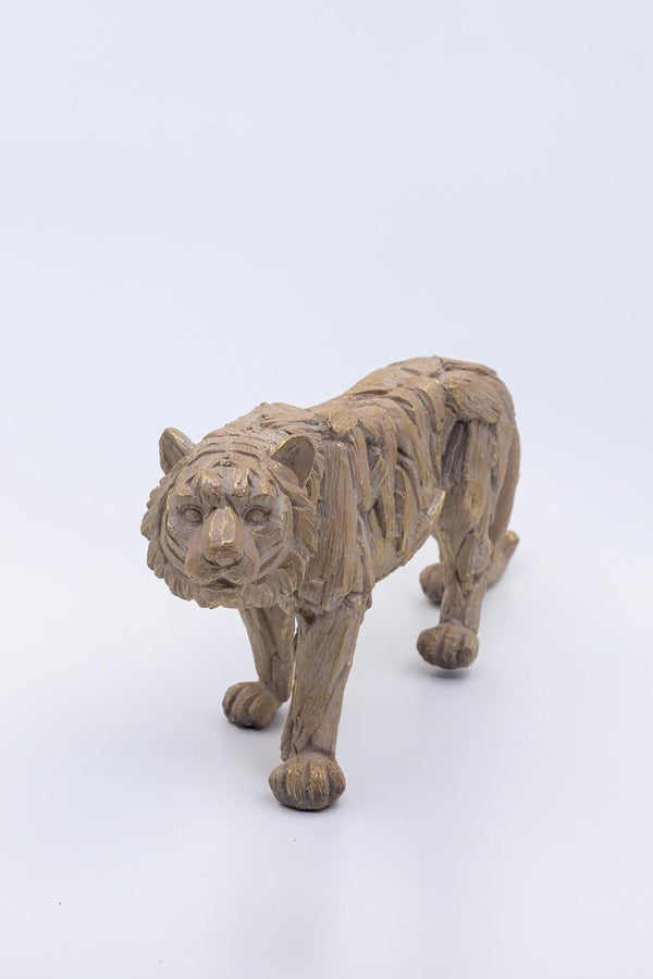 Driftwood sculpture of a tiger on a white background