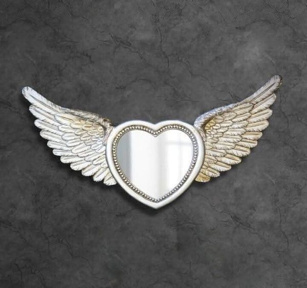 Silver heart mirror displayed on wall