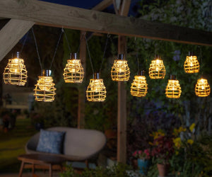 String of hanging solar lights in a garden setting