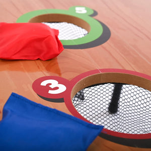 Close-up of a cornhole board with bags and numbered sections on a wooden surface
