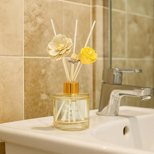 Decorative diffuser with floral elements on a bathroom counter