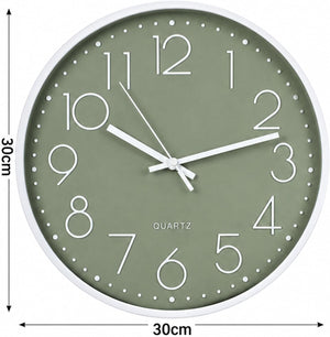 A round wall clock with a sage green dial, white frame, and white numerals and hands, shown with dimension markers indicating a 30cm width and 30cm height.