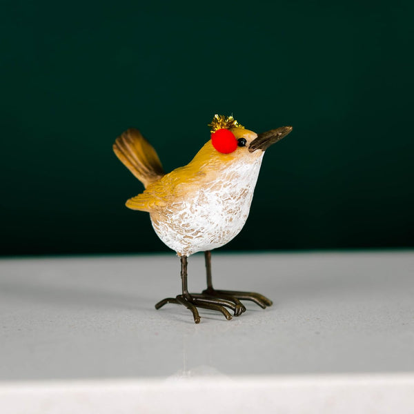 Decorative bird figurine with a red nose on a dark background