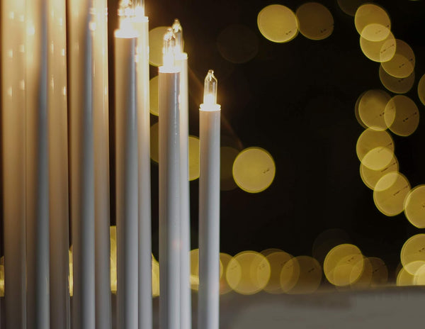 Candlesticks with lights against a blurred bokeh background