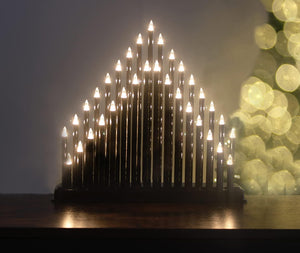 Decorative light fixture with a triangular arrangement of lights against a dark background.