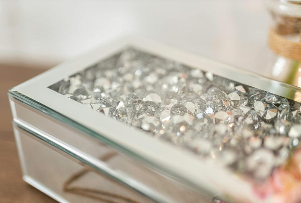 Decorative jewelry box with crystal embellishments on a blurred background