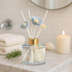 Reed diffuser with floral design on a bathroom counter