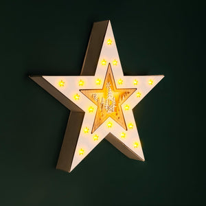 Star-shaped light fixture with glowing interior on a dark background