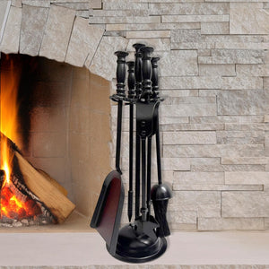 Black fireplace tool set in front of a lit fireplace with stone wall background