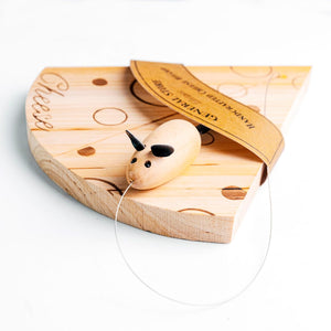 A wooden cheese wheel toy with a small wooden mouse hanging from a clear string, displayed on a white background with its paper packaging tag partially covering the top.