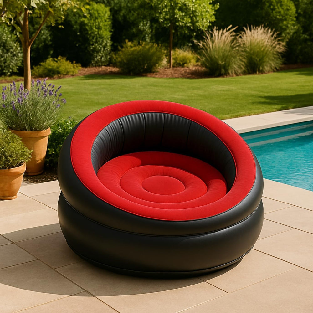 Inflatable red and black chair by a pool with garden and plants in the background