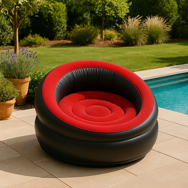 Inflatable red and black chair by a pool with garden and plants in the background