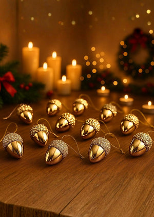 Decorative gold acorn ornaments on a string with candles and Christmas wreath in the background.