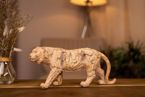 Wooden sculpture of a tiger with detailed texture on a dark background