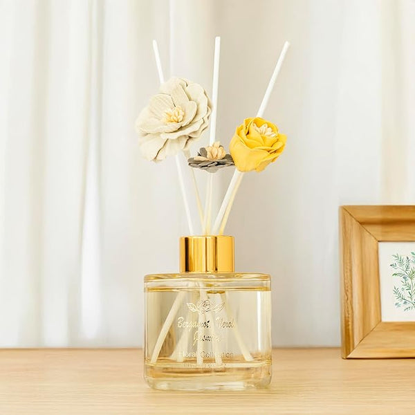Decorative diffuser with floral elements on a wooden surface
