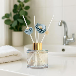 Diffuser with floral design on a bathroom counter