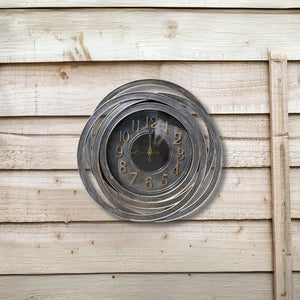 Decorative wall clock with spiral design on a wooden wall