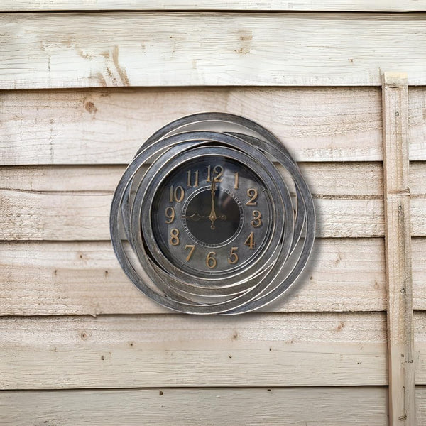 Decorative wall clock with spiral design on a wooden wall