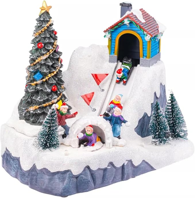 Christmas-themed diorama with a snow-covered igloo, Christmas tree, and small figures on a grey flat surface with a dark blurred background