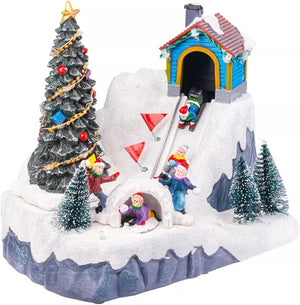 Christmas-themed diorama with a snow-covered igloo, Christmas tree, and small figures on a white background