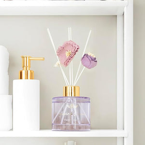 Decorative diffuser with floral elements on a shelf