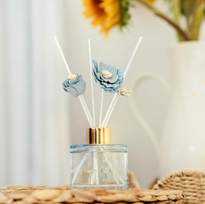 Diffuser with floral design on top against a blurred background