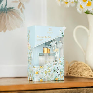 Perfume bottle with floral packaging on a wooden surface