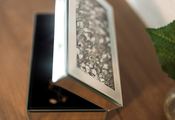 Close-up of a textured metal box on a wooden surface