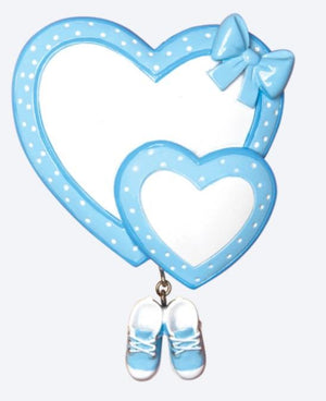 Blue heart-shaped mirror with a bow and baby shoes on a white background
