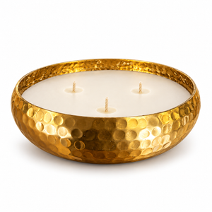 A three-wick soy wax candle in a hammered gold metal bowl, photographed on a clean white background.