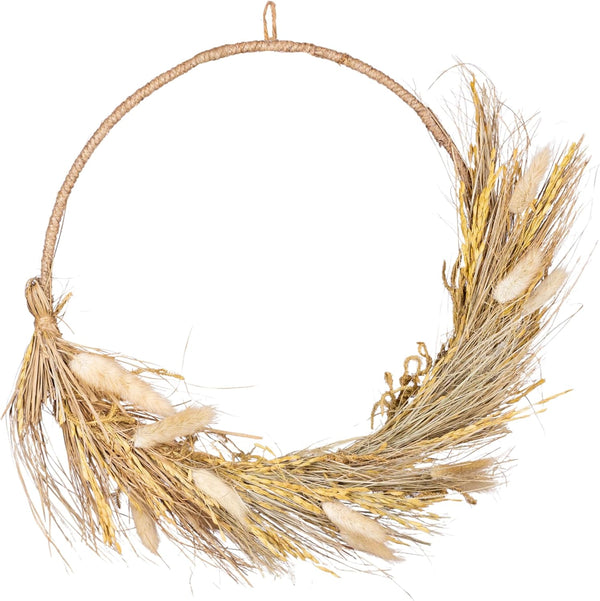 Wreath made of dried grasses and seeds on a white background