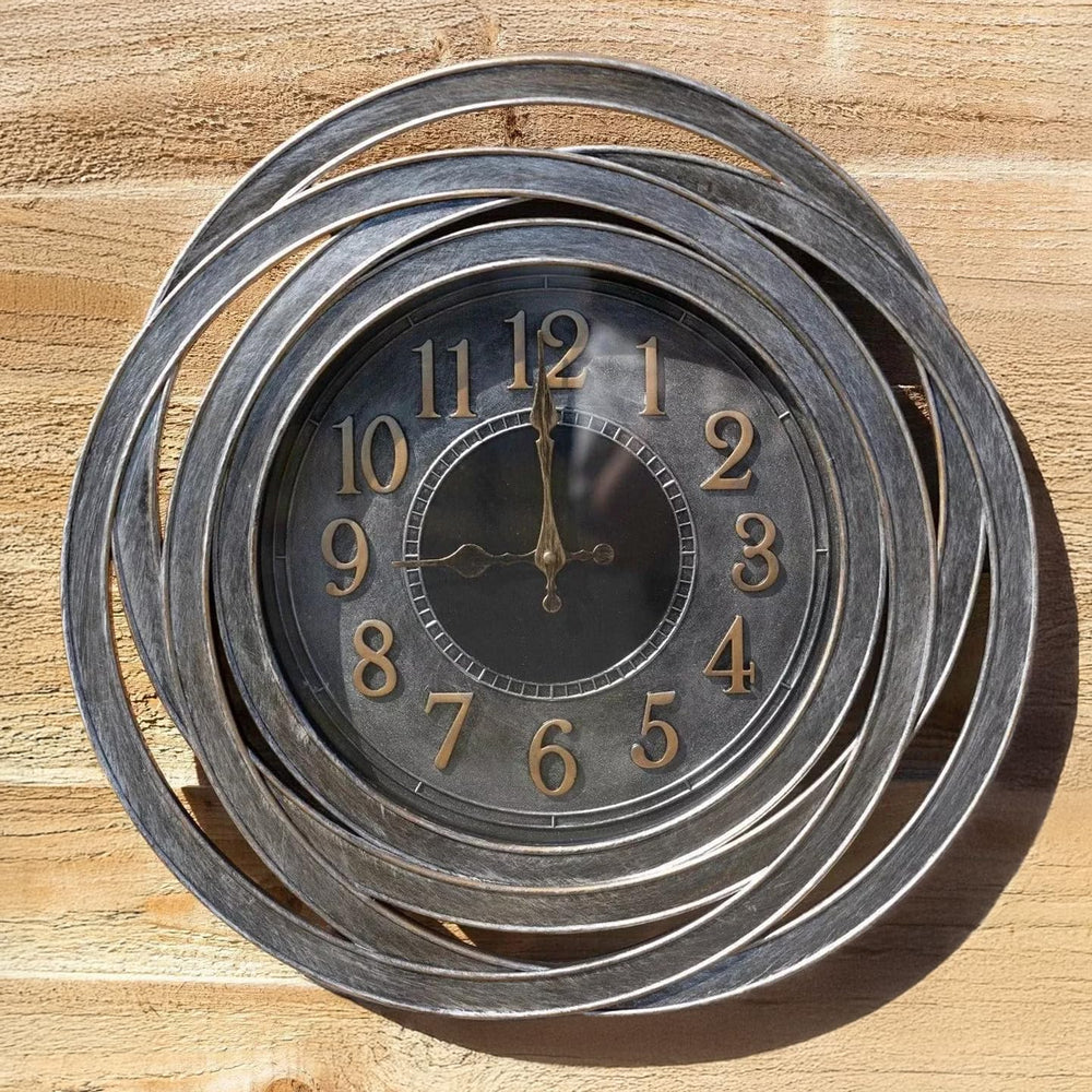Decorative wall clock with spiral design on a wooden background