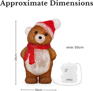 A lit Christmas teddy bear decoration with a red Santa hat and red scarf, shown with dimension labels: 34 cm tall, 19 cm wide, and wire length 50 cm on a white background.