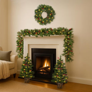 Decorated fireplace with Christmas wreath, garland, and trees in a living room.