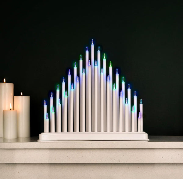 Decorative candle arrangement with multicolored lights on a dark background