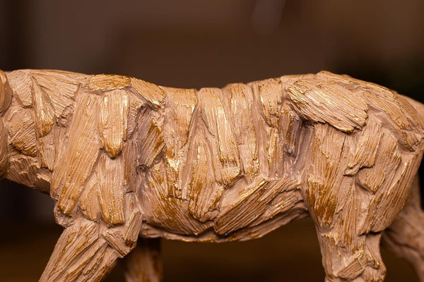 Wooden sculpture of a tiger with detailed texture on a dark background