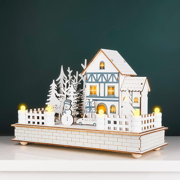Decorative house model with lights on a dark background