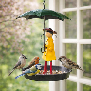 Bird feeder with a figurine holding an umbrella and birds around it